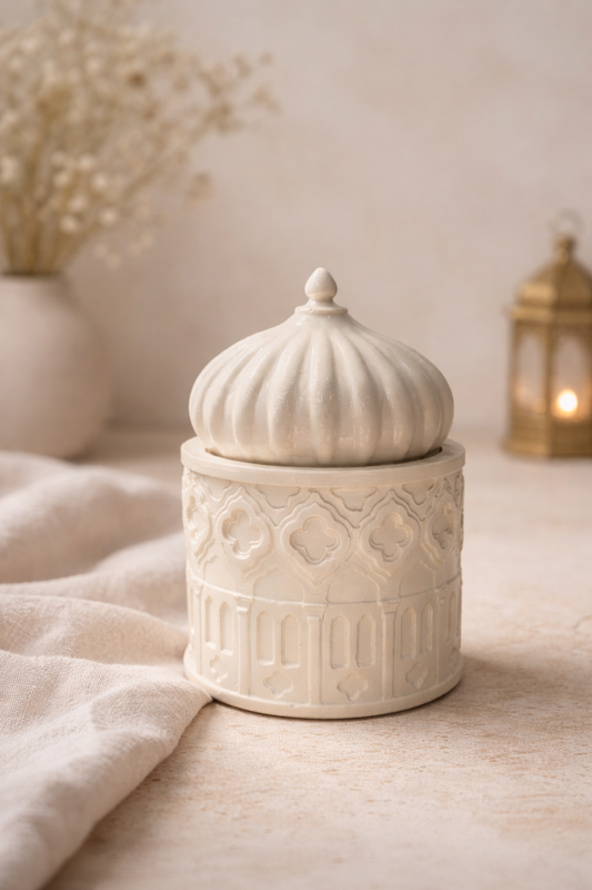 Decorative concrete jar with intricate patterns on a neutral background