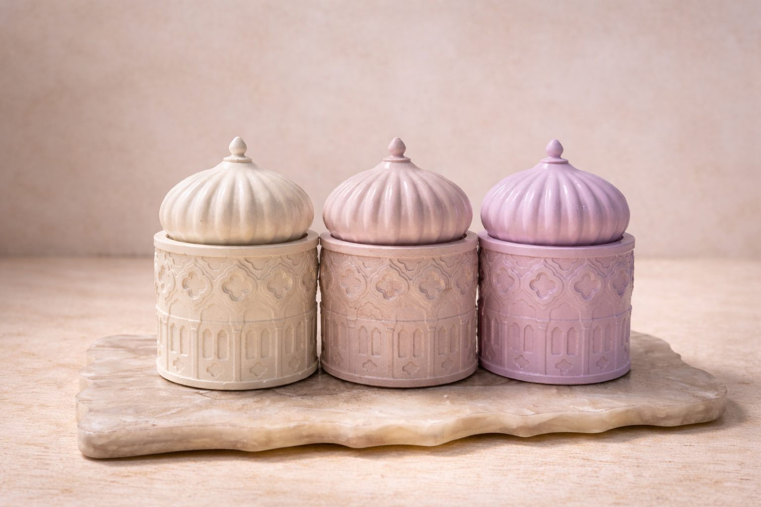 Three concrete jars with textured lids on a wooden surface