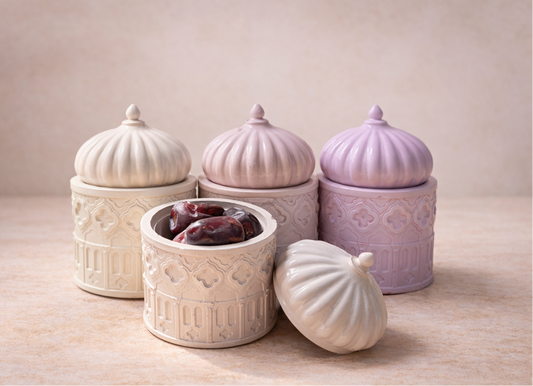 Set of concrete jars with decorative lids on a wooden surface