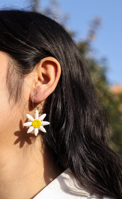 Daisy hoop earrings worn by a girl